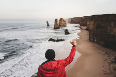 Rear view of man standing on beach