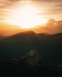 Scenic view of mountains against sky during sunset