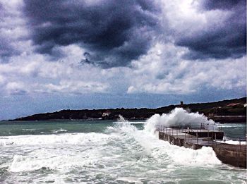 Scenic view of sea against cloudy sky