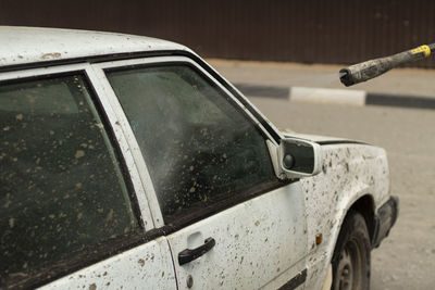 Close-up of wet car on street