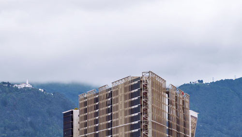 Low angle view of buildings in city against sky