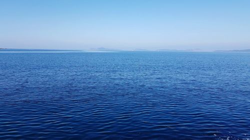 Scenic view of sea against clear blue sky