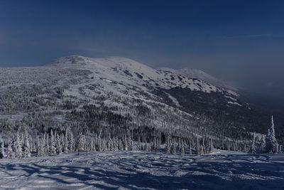 Sunny winter morning in the mountains of sheregesh on the ski track