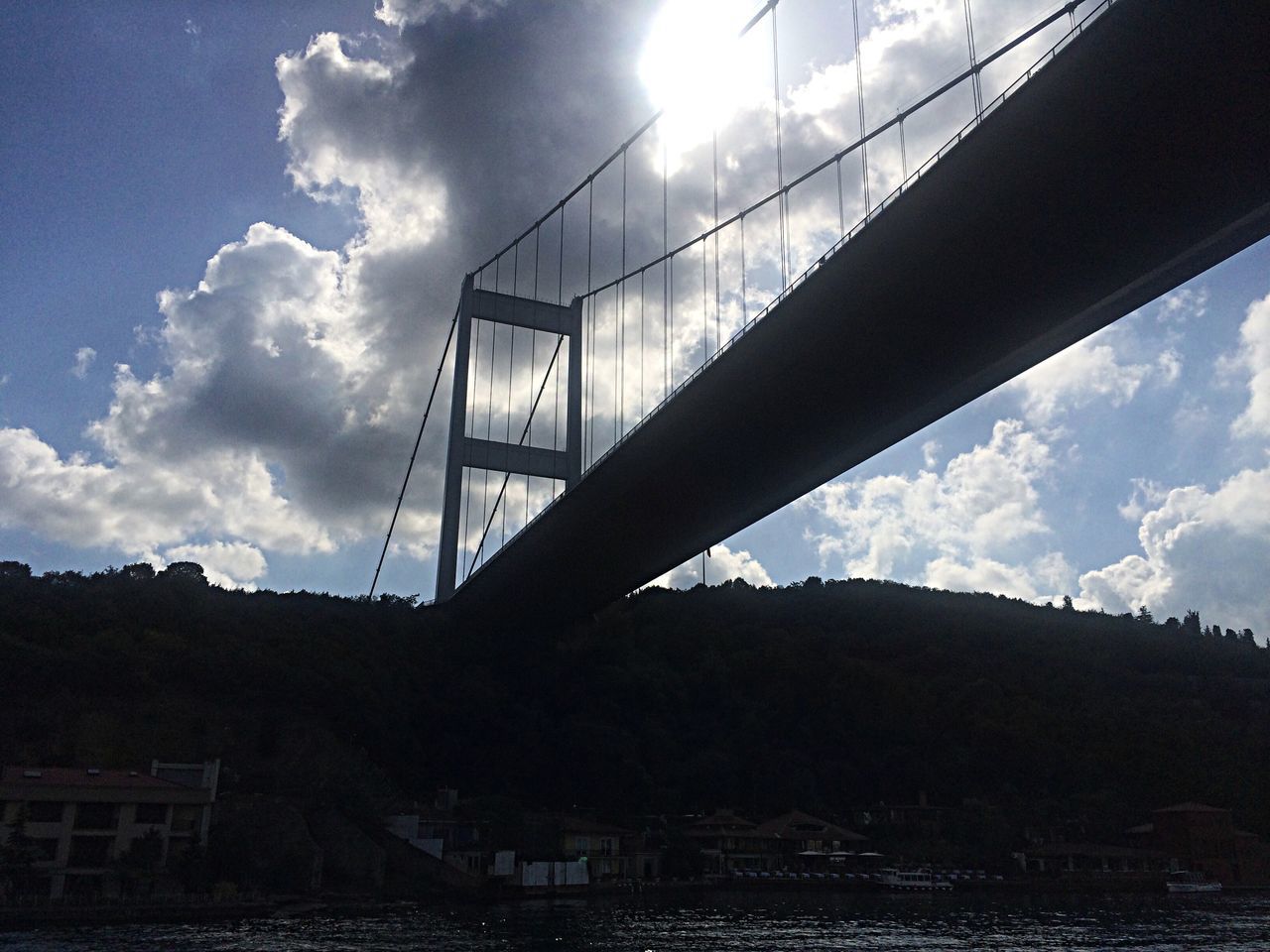 built structure, architecture, low angle view, sky, bridge - man made structure, connection, cloud - sky, engineering, bridge, cloud, silhouette, railing, sunlight, suspension bridge, no people, outdoors, day, cloudy, mountain, transportation
