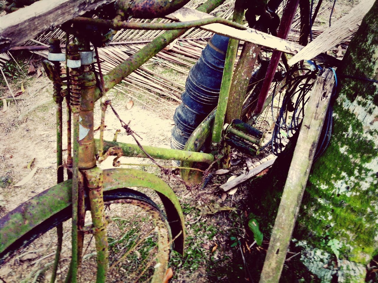 high angle view, built structure, old, architecture, obsolete, abandoned, day, tree, outdoors, history, the past, no people, damaged, bicycle, deterioration, wood - material, nature, sunlight, run-down, wheel