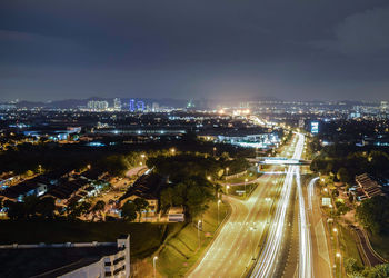 High angle view of illuminated cityscape against sky at night