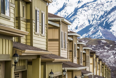 Residential buildings against sky during winter