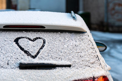 Close-up of heart shape on snow