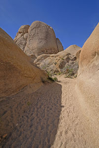 Rock formations on landscape against clear sky