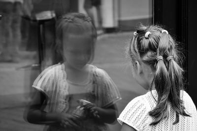 Reflection of girl on window