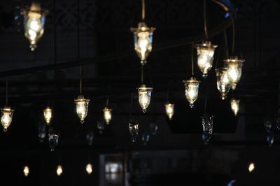 Light bulbs hanging in dark room