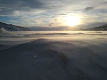 Scenic view of beach against sky during sunset