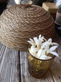 Close-up of white flowers in basket on table