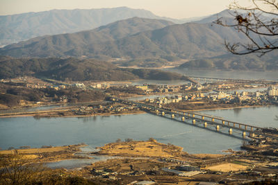 Bridge over river with city in background