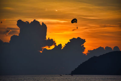 Amazing wonderful dramatic golden colored sky behind the clouds during a stunning sunset in langkawi