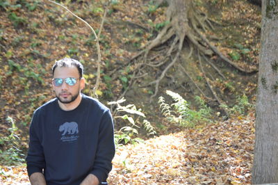 Portrait of boy standing in forest