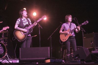 People playing guitar at music concert