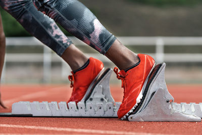 Low section of person wearing red shoes