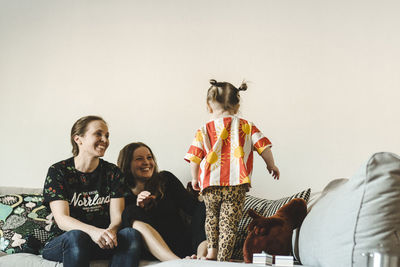 Girl with mothers on sofa