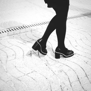 Low section of woman standing on ground