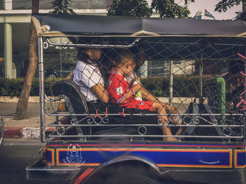 People traveling in jinrikisha