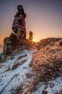 Rock formations against sky during sunset