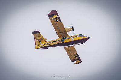 Low angle view of airplane against clear sky