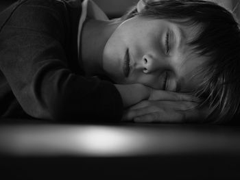 Portrait of baby sleeping on bed at home