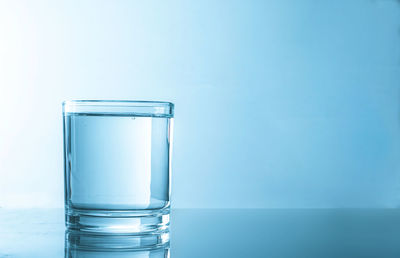 Close-up of glass against blue background