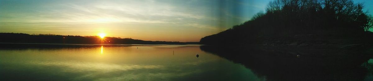 Scenic view of calm lake at sunset