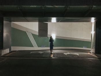 Rear view of man standing by wall