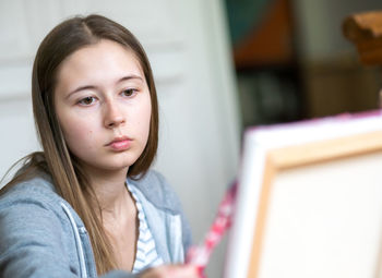 Portrait of teenage girl at home