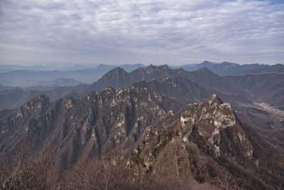 Panoramic view of mountains against cloudy sky