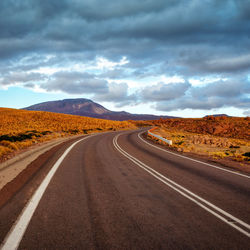 Empty road along countryside landscape