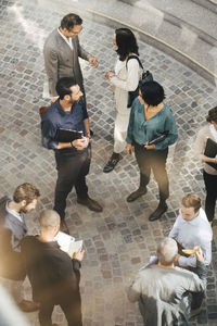 High angle view of male and female business people standing outdoors