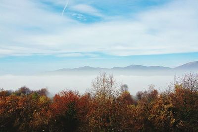 Scenic view of mountains against cloudy sky