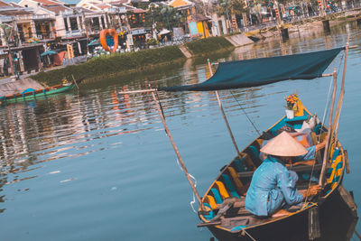 Men sitting on boat in river