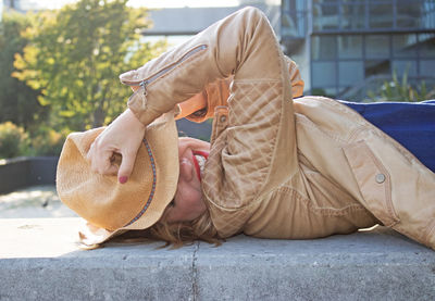 Side view of woman sitting outdoors