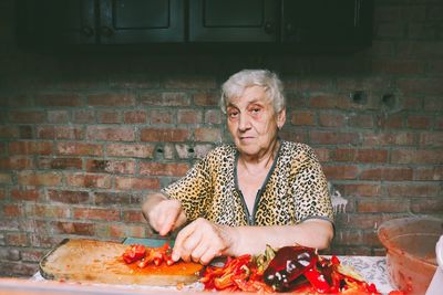 Young woman eating food at home