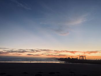 Scenic view of beach against sky during sunset