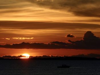 Scenic view of sea against orange sky