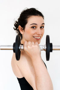 Portrait of young woman exercising in gym