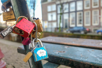 Close-up of love padlocks on railing against building