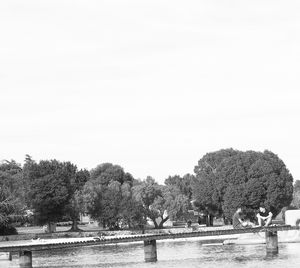 Scenic view of river by trees against clear sky