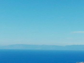 Scenic view of sea against blue sky