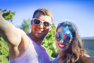 Portrait of smiling young woman wearing sunglasses