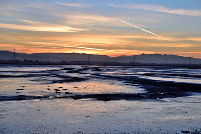 Scenic view of beach against sky during sunset