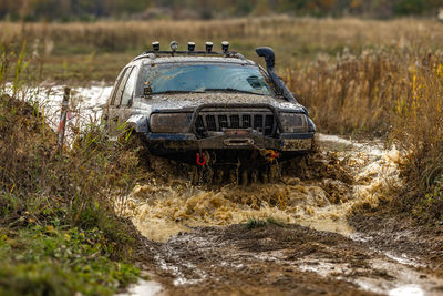 Abandoned car on field
