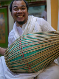 Portrait of smiling man sitting outdoors