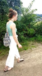 Side view of woman standing on field